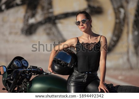 Biker young beauty girl on a motorcycle
