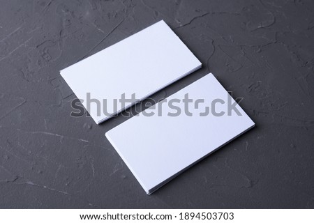 Business card blank on beton rock background. Corporate Stationery, Branding Mock-up. Creative designer desk. Flat lay. Copy space for text. Template for ID.