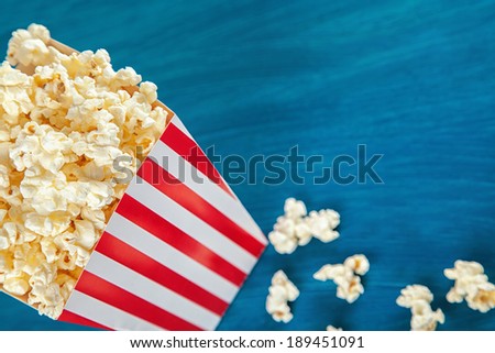 Box of popcorn on blue background