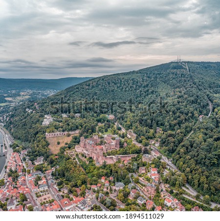 Aerial drone shot of Heidelberg old town in overcast summer at foot of Konigstuhl mountain