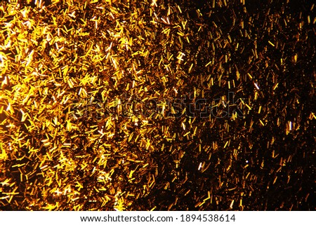 Gold sequins. Christmas, holiday background. Sparkles of golden plate texture background.