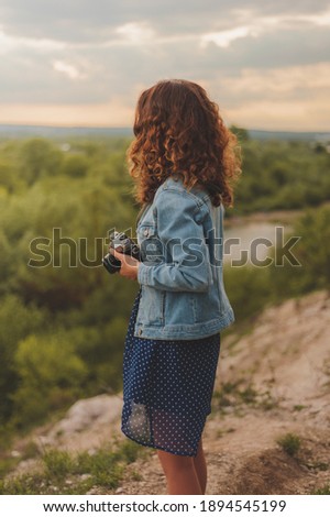 young girl takes pictures of nature