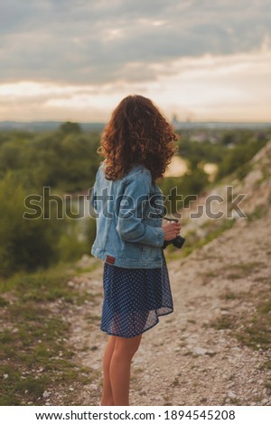 young girl takes pictures of nature