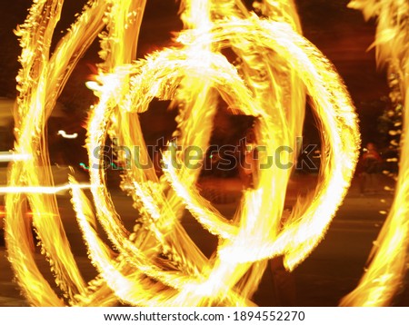 Image of fire show picture. Bright golden rounds. Light vortex. Concept of the beauty in the abstraction.