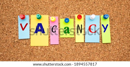 Color notes with letters pinned on a board. Word VACANCY. Work space. Royalty-Free Stock Photo #1894557817