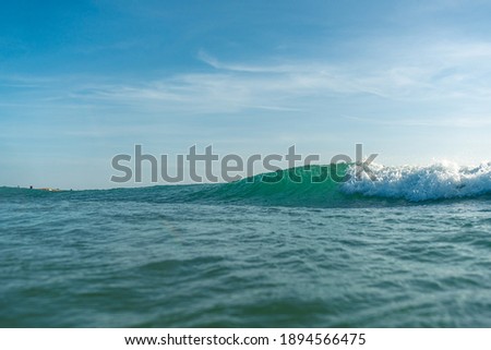 Breaking Waves and spray, white water and light reflecting on the surface of the moving water