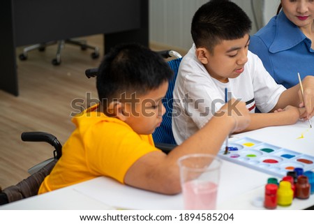 Asian disability child boy and Autism kid learning drawing in classroom