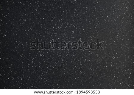 abstract black and white photo texture background of grainy powder coating surface with white spots