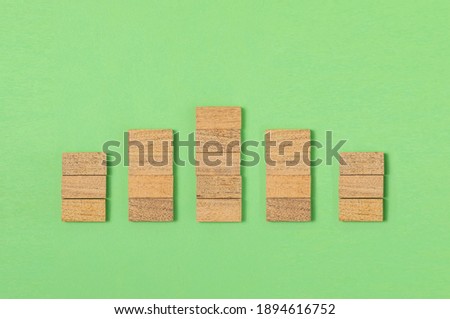 Wooden block stacking as step stair  on green background, Ladder of success in business growth concept, copy space
