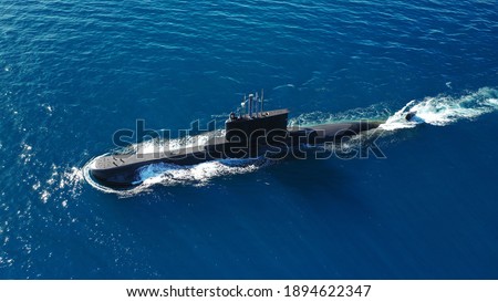 Aerial drone photo of latest technology naval armed forces submarine cruising in deep blue open ocean sea Royalty-Free Stock Photo #1894622347