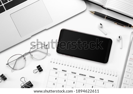 Composition with smartphone and laptop on white background, top view