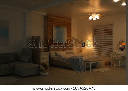 Stylish apartment interior with modern ceiling fan in evening Royalty-Free Stock Photo #1894628473