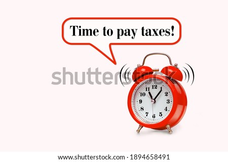 Time to pay taxes - text on light pink background with red alarm clock