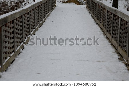 Medieval oak wood, bolted. Bridge over the moat. the railing is made of massive beams, between which several thin oak rods are woven between the vertical warp. Zigzag like knitting a wicker basket.
