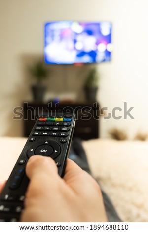hand holding tv remote close-up