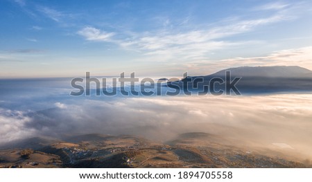 Crimea. Golden autumn. The view from the mountain Demerdzhi. The photo was taken from a drone at sunset. Above the clouds.