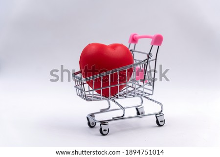 Red heart ball put in steel cart  on white background,tell bring heart to sell or give someone who in love.