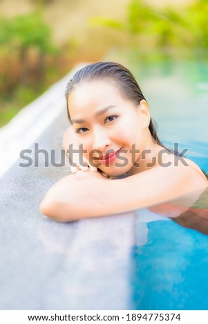 Portrait beautiful young asian woman enjoy relax around swimming pool for leisure vacation