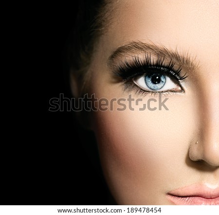Beauty makeup for blue eyes. Part of beautiful face closeup. Perfect skin, long eyelashes. Make up concept. isolated on black background Royalty-Free Stock Photo #189478454