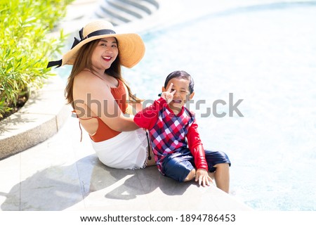 Happy family. Mother and baby swim in the pool