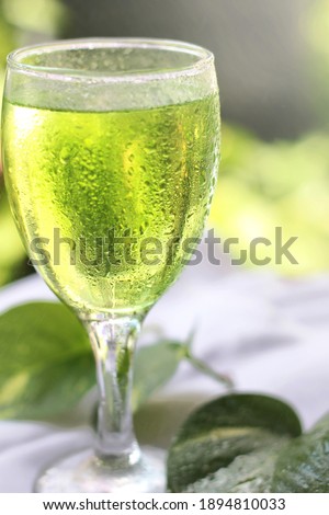 a glass of cold water with dew around the glass, with selected focus in the morning.
