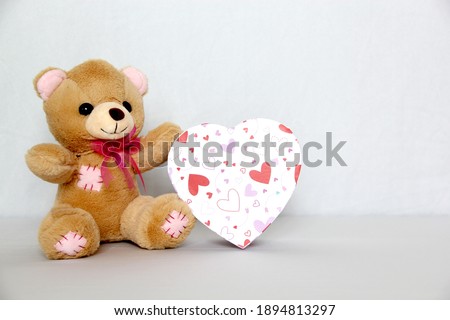 
teddy bear, box of chocolates and pink hearts with ribbon on white background, Valentine's Day gifts, advertising banner