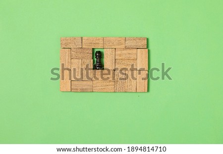 Pieces of wood joined with a different piece in the center on green background, Ladder of success in business growth concept, copy space