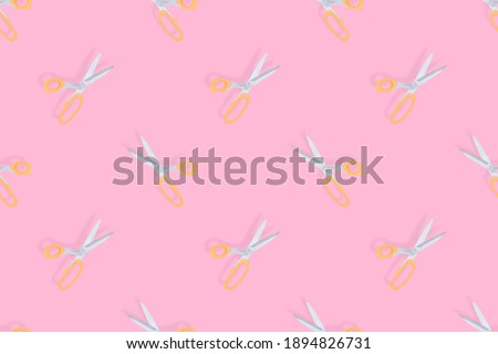 Scissors seamless pattern. Hairdressing scissors against pink background backdrop.