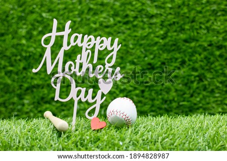 Baseball for mom on Mother's Day with baseball on green grass background