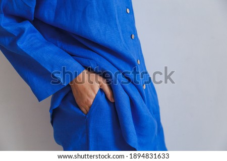 Woman's hand in the pocket of cozy blue pajamas. High quality photo