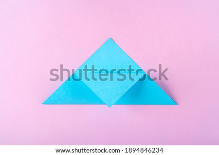 DIY and kid's creativity, origami. Step by step instruction: how to make bookmark easter bunny. Step4  Bend top of triangle to middle of lower side. Easter craft