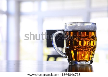 Glass of fresh beer on a wooden table. Lager beer mug on stone table. Top view copy space
