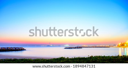 Seascape twilight and industrial estates with light illumination at night time on background