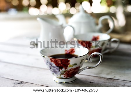 colorful English tea cup on a teal table