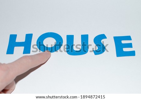 Word House in blue letters and forefinger.