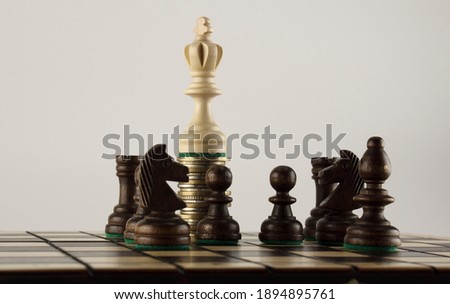 Chess board, chess pieces and money. Strong financial capital advantage concept, financial power concept. Royalty-Free Stock Photo #1894895761