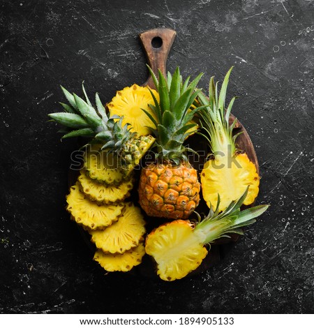 sliced juicy pineapples. Ripe baby pineapple. Tropical fruits. Top view. Free space for text.