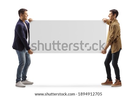 Full length profile shot of two casual men carrying a blank panel isolated on white background
