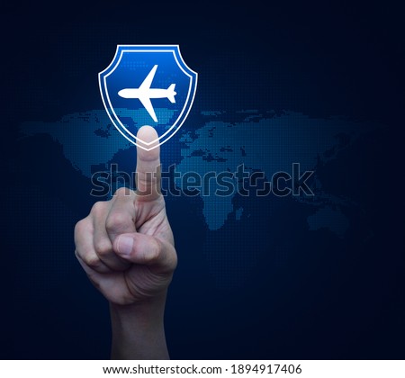 Hand pressing airplane with shield flat icon over digital world map technology style, Business travel insurance and safety concept, Elements of this image furnished by NASA