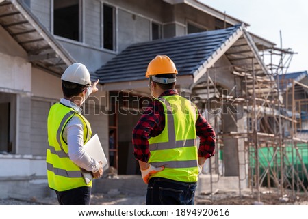 Engineer recommend house construction to supervisor supervisors at construction site. House builder concept.