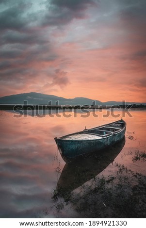 solo boat sailing sunrise reflection