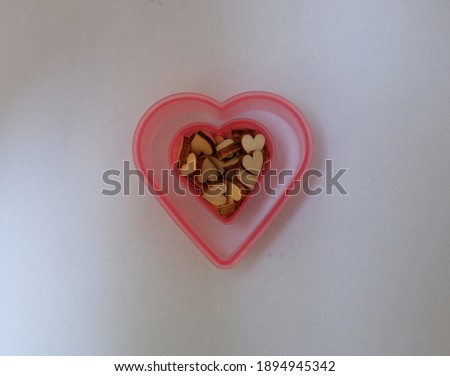 wooden heart of different sizes in heart-shaped mold