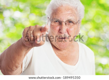 portrait of pretty elder woman pointing to the front