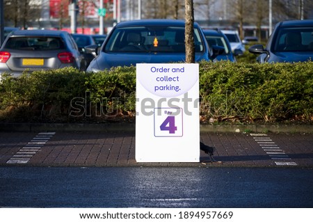 Click collect online internet shopping sign at shop car park lane 