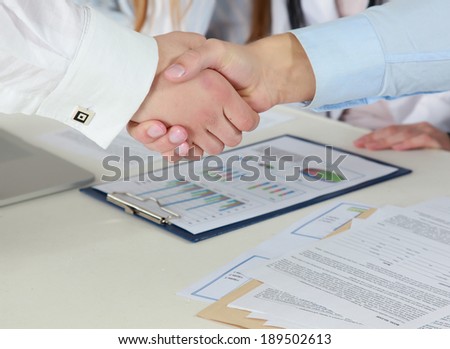 Handshake in front of business people