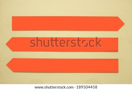 left-right directional orange arrow on the wall background.