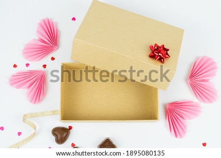 Open cardboard box with Valentine's Day, anniversary, mother's day and birthday decorations. Free space for text. Mockup .