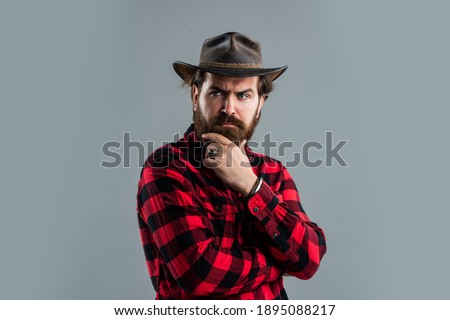 Looking good. mature guy with beard and moustache. male casual fashion style. handsome hipster with cowboy hat. barbershop concept. hair grooming and care. brutal bearded man in checkered shirt.