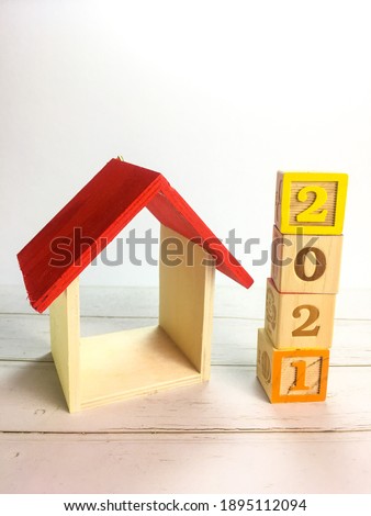 Wooden block with word of new year 2021.  Inscription with replica house. There are several different types of arrangements. Selective focus. 