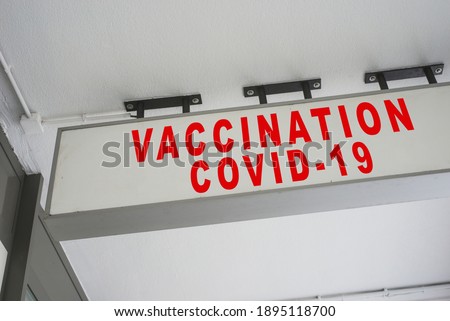 closeup of vaccination covid-19 signboard entry on white building background